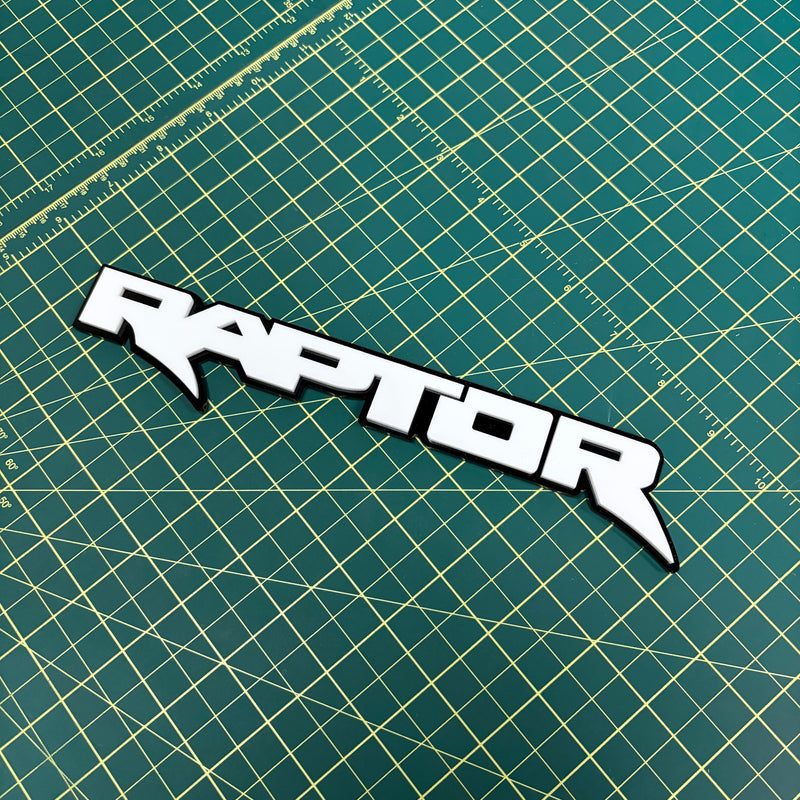 Load image into Gallery viewer, white Raptor emblem on a green mat
