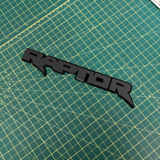Raptor Emblem in matte black on green mat