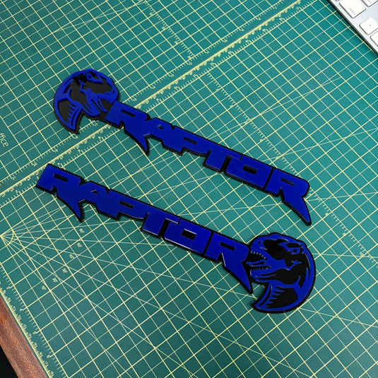 Two raptor emblems with dinosaur heads in deep blue